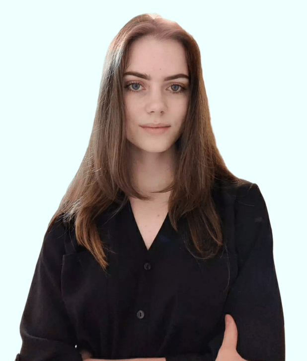 A headshot of Mikayla Deehring, a white woman with long brown hair standing in front of a light blue background.